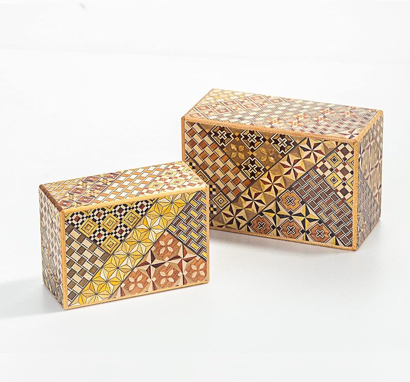 Two yosegi secret boxes with mosaic patterns on a white background